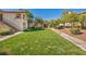 Well-maintained green space with lush grass, mature trees, and walking paths at 8501 W University Ave # 1083, Las Vegas, NV 89147