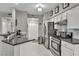 Bright kitchen features stainless steel appliances, grey countertops, and white tile flooring at 8501 W University Ave # 1083, Las Vegas, NV 89147