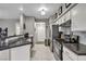 Well-lit kitchen showcases stainless appliances, tile floors, and a sleek design at 8501 W University Ave # 1083, Las Vegas, NV 89147