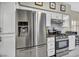 Modern kitchen boasts stainless steel appliances, white cabinets, and sleek countertops at 8501 W University Ave # 1083, Las Vegas, NV 89147