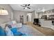 Open-concept living area with a modern ceiling fan and seamless flow to the kitchen at 8501 W University Ave # 1083, Las Vegas, NV 89147