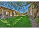 Community picnic area surrounded by mature trees and lush greenery, with grill at 8501 W University Ave # 1083, Las Vegas, NV 89147