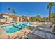 Stunning pool area featuring comfortable lounge chairs, lush landscaping, and community amenities at 8501 W University Ave # 1083, Las Vegas, NV 89147