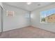 This is a carpeted bedroom with three windows and an open closet at 9021 Last Hope Ave, Las Vegas, NV 89178