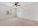 A carpeted bedroom with a ceiling fan, large window and lots of natural light at 9021 Last Hope Ave, Las Vegas, NV 89178