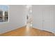 Second story bedroom with hardwood flooring, a window, and a white door at 9021 Last Hope Ave, Las Vegas, NV 89178