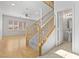 Bright entryway showcasing a staircase, bathroom, and wood laminate flooring at 9021 Last Hope Ave, Las Vegas, NV 89178