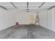 Spacious two-car garage featuring concrete floor and an entry door at 9021 Last Hope Ave, Las Vegas, NV 89178