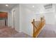 Upstairs hallway with wood railing and easy access to laundry room at 9021 Last Hope Ave, Las Vegas, NV 89178