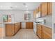 Functional kitchen with wooden cabinetry, neutral countertops, and tile flooring at 9021 Last Hope Ave, Las Vegas, NV 89178