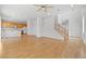 Spacious living room with an adjacent kitchen, and wood laminate flooring at 9021 Last Hope Ave, Las Vegas, NV 89178