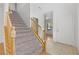 Carpeted staircase with wooden railing leading to the upper level of the home at 9021 Last Hope Ave, Las Vegas, NV 89178