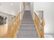 Carpeted staircase with wooden railing leading to the upper level of the home at 9021 Last Hope Ave, Las Vegas, NV 89178