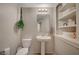 Small half bathroom with pedestal sink and open shelving at 9327 S Chieftain St, Las Vegas, NV 89178