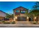 Stylish two-story home with a two car garage, manicured lawn, and inviting curb appeal at 9327 S Chieftain St, Las Vegas, NV 89178