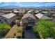 Aerial view of charming house with manicured yard and inviting front porch at 9327 S Chieftain St, Las Vegas, NV 89178