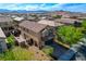 Beautiful two-story home featuring a well-manicured yard and a charming, arched entryway at 9327 S Chieftain St, Las Vegas, NV 89178