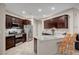 Modern kitchen with granite countertops, stainless steel appliances, and dark wood cabinets at 9327 S Chieftain St, Las Vegas, NV 89178