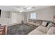 Cozy living room featuring a large sectional sofa, plush rug, and neutral decor at 9327 S Chieftain St, Las Vegas, NV 89178
