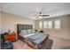 Spacious bedroom with a large bed, three windows with plantation shutters, and neutral tones at 9327 S Chieftain St, Las Vegas, NV 89178