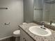 Clean bathroom featuring a vanity with a granite countertop, a white sink, and modern fixtures at 9333 Leaping Deer Pl # 103, Las Vegas, NV 89178