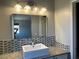 Updated bathroom vanity featuring decorative mirror and granite countertops at 9333 Leaping Deer Pl # 103, Las Vegas, NV 89178