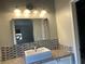 Modern bathroom featuring tiled backsplash and a vessel sink at 9333 Leaping Deer Pl # 103, Las Vegas, NV 89178