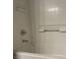 Bathroom features a tub with tile surround and modern fixtures at 9333 Leaping Deer Pl # 103, Las Vegas, NV 89178