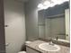 Well-lit bathroom featuring granite countertops, a large mirror, and a shower with a tub at 9333 Leaping Deer Pl # 103, Las Vegas, NV 89178