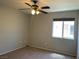 Simple bedroom featuring a carpeted floor, ceiling fan, and window at 9333 Leaping Deer Pl # 103, Las Vegas, NV 89178