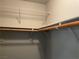 Bright closet featuring wood rod, shelves, and white walls at 9333 Leaping Deer Pl # 103, Las Vegas, NV 89178