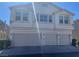 Two-story home with three-car garage and well-maintained landscaping in a residential neighborhood at 9333 Leaping Deer Pl # 103, Las Vegas, NV 89178