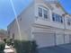 Charming two-story home with a three-car garage and manicured landscaping, showcasing curb appeal at 9333 Leaping Deer Pl # 103, Las Vegas, NV 89178