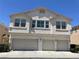Inviting townhouse featuring a three-car garage and neutral-toned stucco exterior at 9333 Leaping Deer Pl # 103, Las Vegas, NV 89178