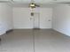 Clean, spacious garage with finished flooring and a ceiling fan at 9333 Leaping Deer Pl # 103, Las Vegas, NV 89178
