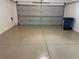 Clean, spacious garage featuring epoxy flooring and a closed garage door at 9333 Leaping Deer Pl # 103, Las Vegas, NV 89178