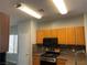 Kitchen featuring stainless steel appliances, oak cabinets, and ample countertop space at 9333 Leaping Deer Pl # 103, Las Vegas, NV 89178