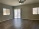 Bright living room featuring modern ceiling fan, wood-look floors and sliding glass doors at 9333 Leaping Deer Pl # 103, Las Vegas, NV 89178