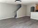 Bright, open-concept living room with laminate flooring and a staircase leading to the upper level at 9333 Leaping Deer Pl # 103, Las Vegas, NV 89178