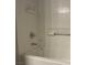 This bathtub features white tile, chrome fixtures, and a built-in storage shelf at 9333 Leaping Deer Pl # 103, Las Vegas, NV 89178