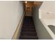 Carpeted stairs lead to the upper level, illuminated by a wall sconce at 9333 Leaping Deer Pl # 103, Las Vegas, NV 89178