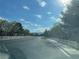 Scenic street view with white fences, mature trees and a blue sky at 9333 Leaping Deer Pl # 103, Las Vegas, NV 89178