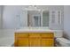 Traditional bathroom with a oak vanity, a large mirror, and a tiled shower at 9552 Wooden Pier Way, Las Vegas, NV 89117