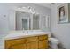Traditional bathroom with a oak vanity, a large mirror, and a tiled shower at 9552 Wooden Pier Way, Las Vegas, NV 89117