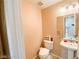 Powder room offers a single sink with a mirror and vanity, a toilet, and fresh paint at 9552 Wooden Pier Way, Las Vegas, NV 89117