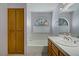 Bathroom featuring a half moon window, neutral walls, and oak cabinets at 9552 Wooden Pier Way, Las Vegas, NV 89117