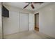 Bedroom with neutral walls and carpet, ceiling fan, closet and television on wall at 9552 Wooden Pier Way, Las Vegas, NV 89117