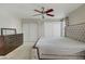 Bright bedroom featuring plush carpet, ceiling fan, and a tufted headboard at 9552 Wooden Pier Way, Las Vegas, NV 89117
