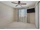 Bright bedroom with neutral walls and carpet, ceiling fan, and large window at 9552 Wooden Pier Way, Las Vegas, NV 89117