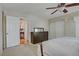 Bedroom with neutral walls and carpet, ceiling fan, closet, and view into hall at 9552 Wooden Pier Way, Las Vegas, NV 89117